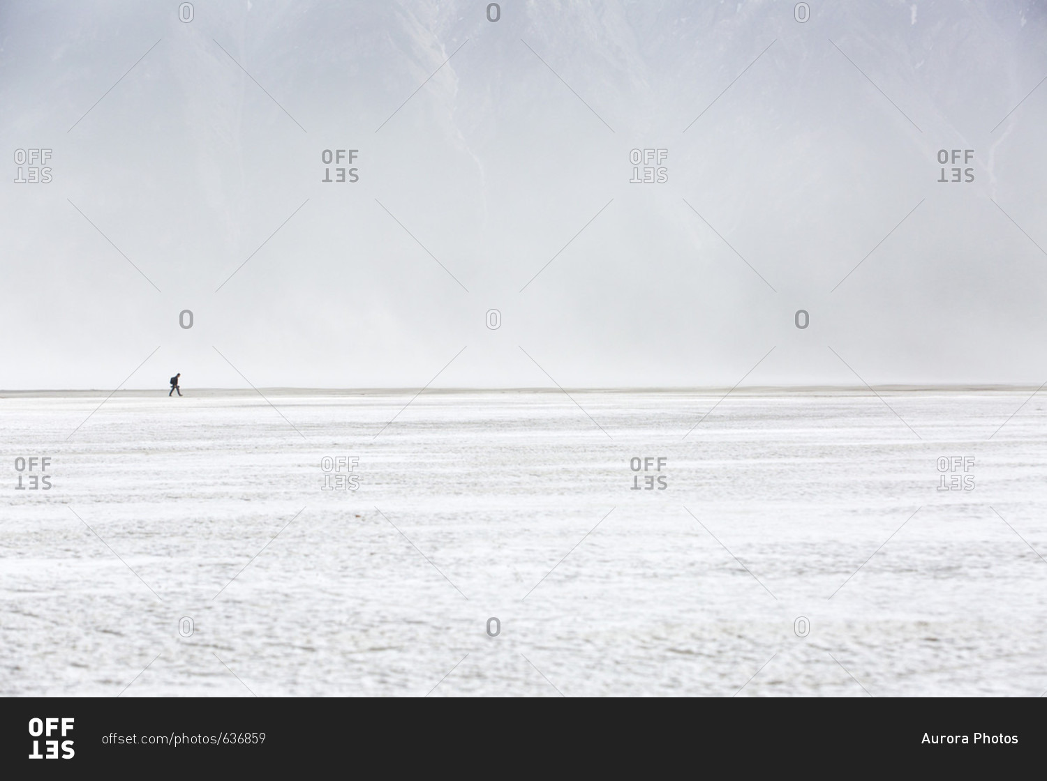 A lone hiker walks through a dust storm in the Sheep Mountain area of Kluane National Park in Canada\'s Yukon.