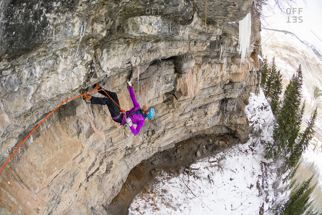 A woman climber becoming the first woman to climb A difficult mixed ice climb called P51 Mustang, rated M14 in the Vail Amphitheater, Vail, Colorado.
