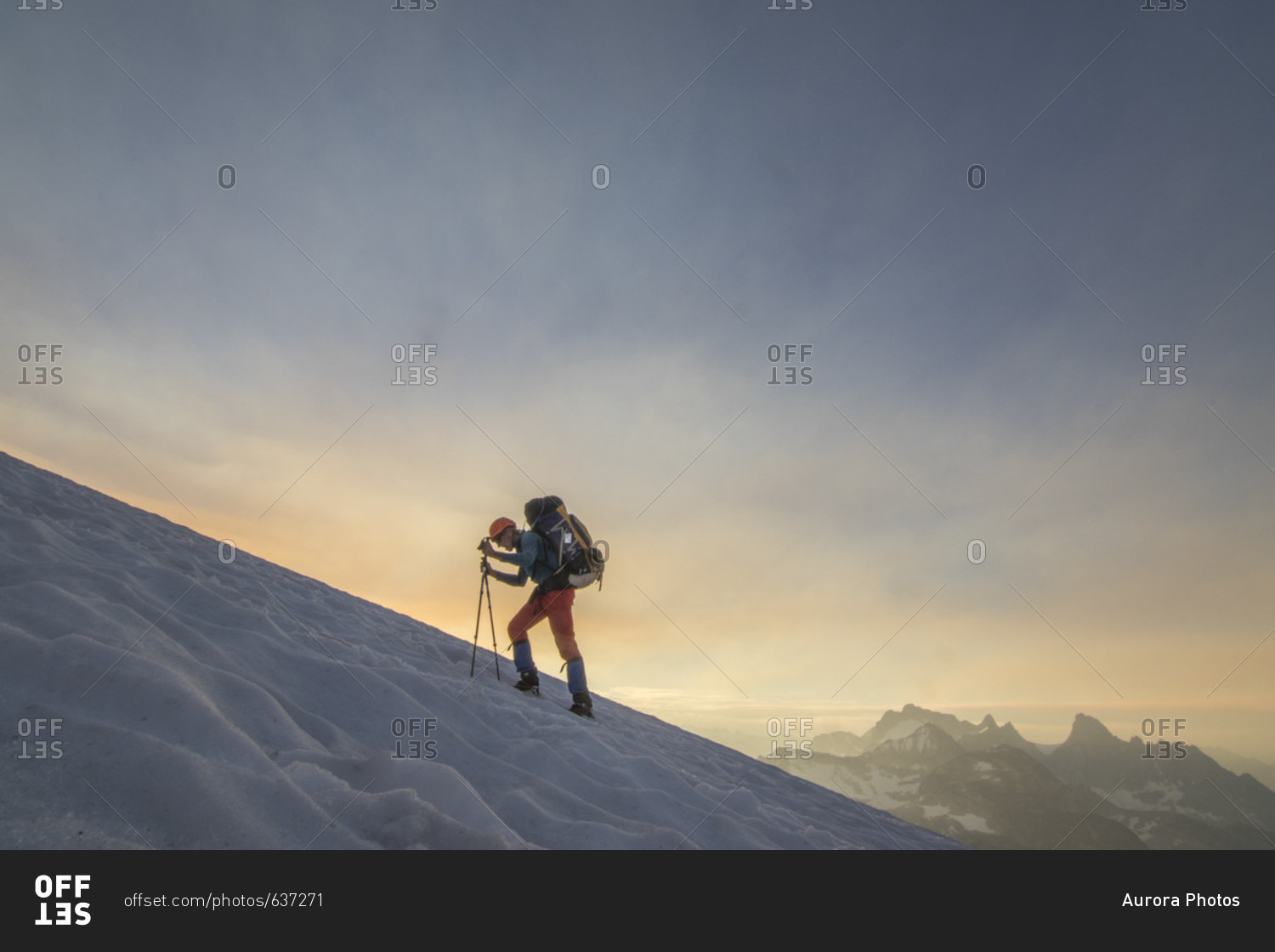 Side view of mountain climber traversing glacier at sunset, Bugaboo Mountains, British Columbia, Canada