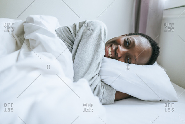 woman laying down smiling stock photos - OFFSET