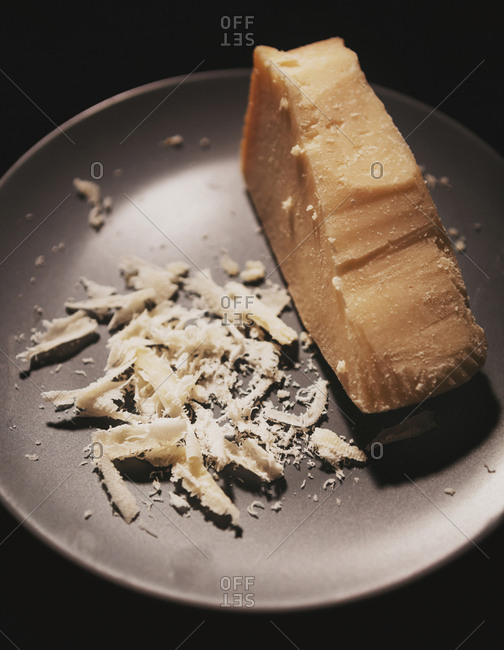 Close up of a parmesan cheese block with shavings stock photo OFFSET