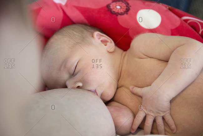 Mother breastfeeding her newborn baby boy