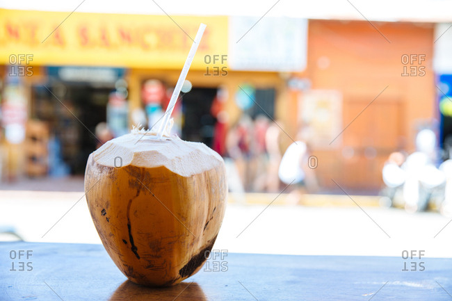 Coconut ready to drink on a table in a street side cafe