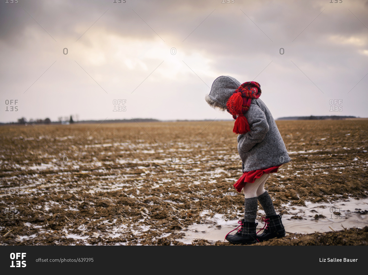 Young girl plays outside in the cold winter