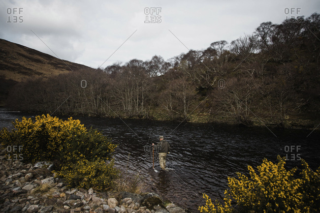 A fly fisherman enjoying the solitude on a river near Bettyhill, Scotland