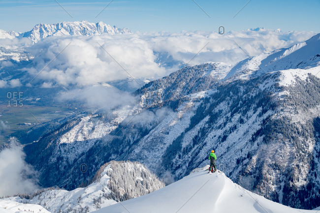 An Alpine skier is standing on the peak of a mountain peak at the Kitzsteinhorn Glacier near Salzburg in Austria