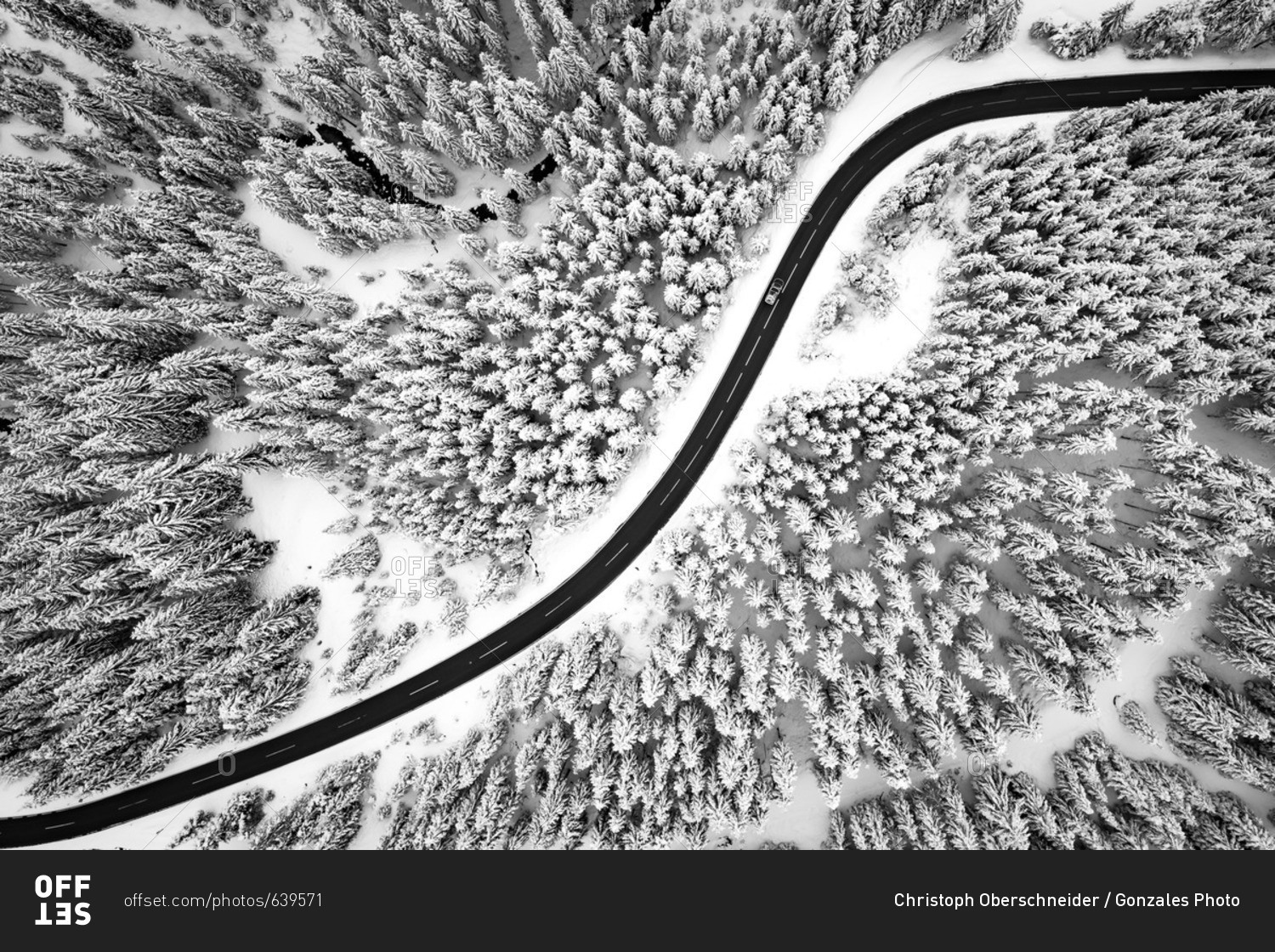 Zauchensee, Austria - April 20, 2017: Bird\'s eye view on a road winding through snow covered trees in the Austrian Alps