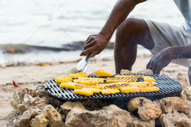 Woman lying on the beach without the bikini top looking at camera