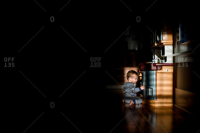 Baby playing with a kitchen play set