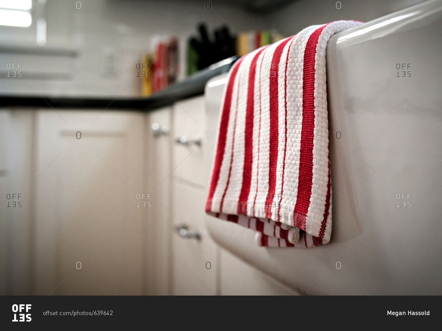 Red and white dish cloth hanging over the kitchen sink