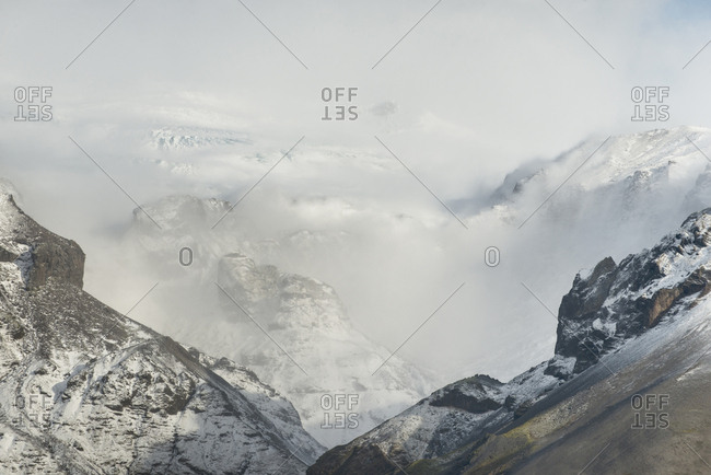 Scenic view of snowcapped mountains during foggy weather