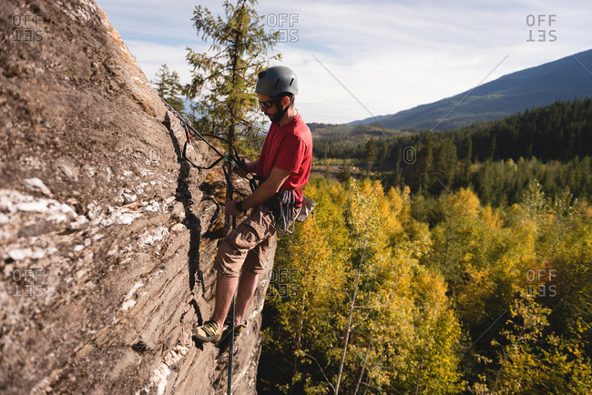 Determined rock climber climbing the rocky mountain