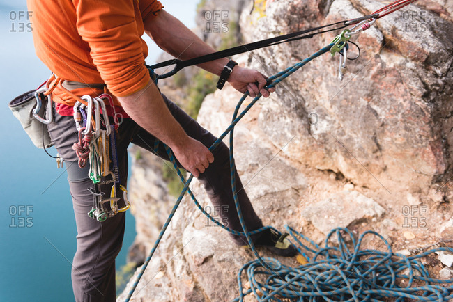 Low section of rock climber climbing the rocky mountain