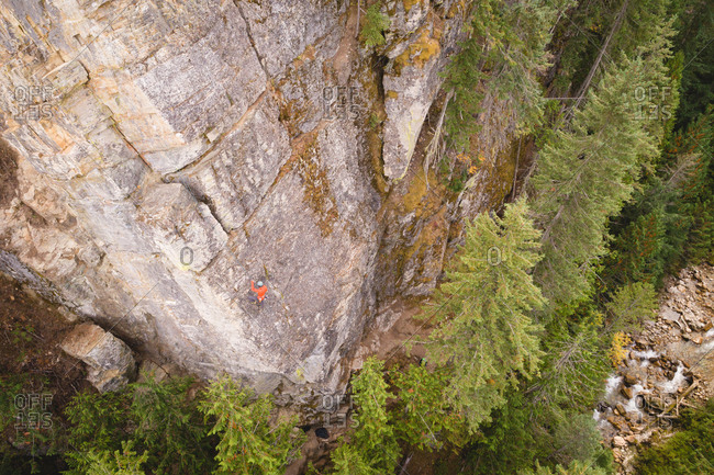 Determined mountaineer climbing the rocky cliff