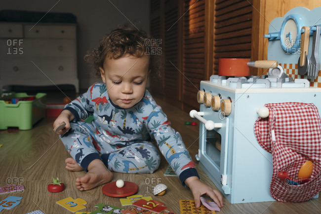 Boy plays with wooden food set