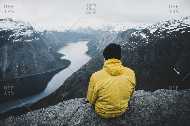 Caucasian man admiring scenic view of mountain river