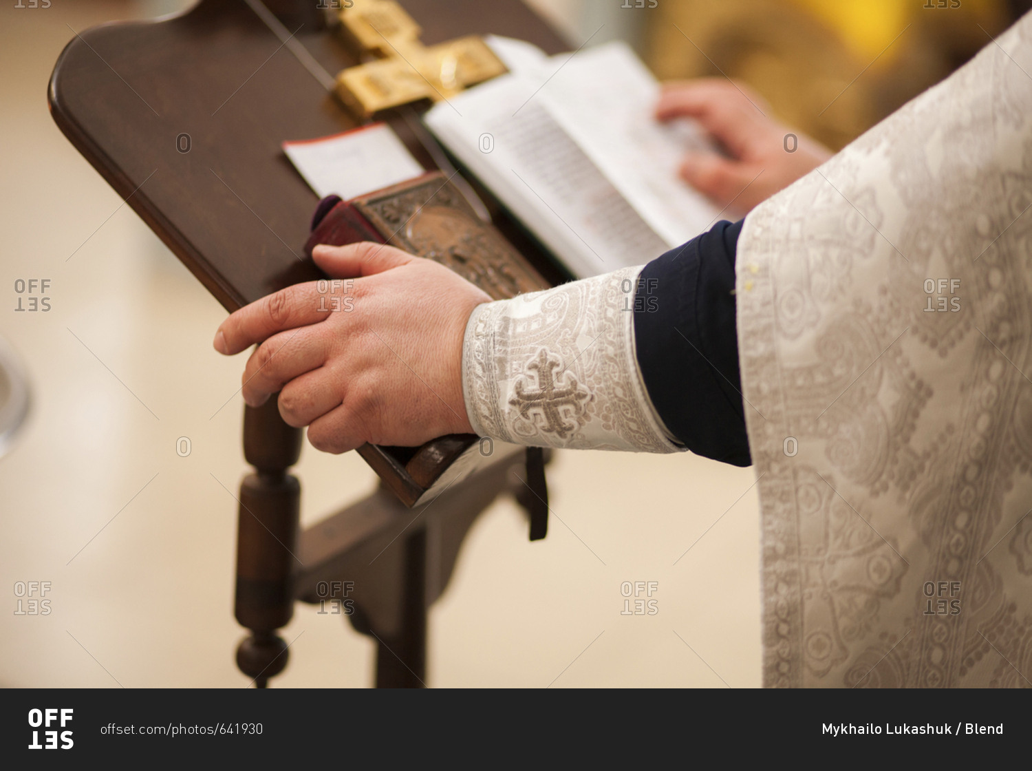 Hands of priest on pulpit