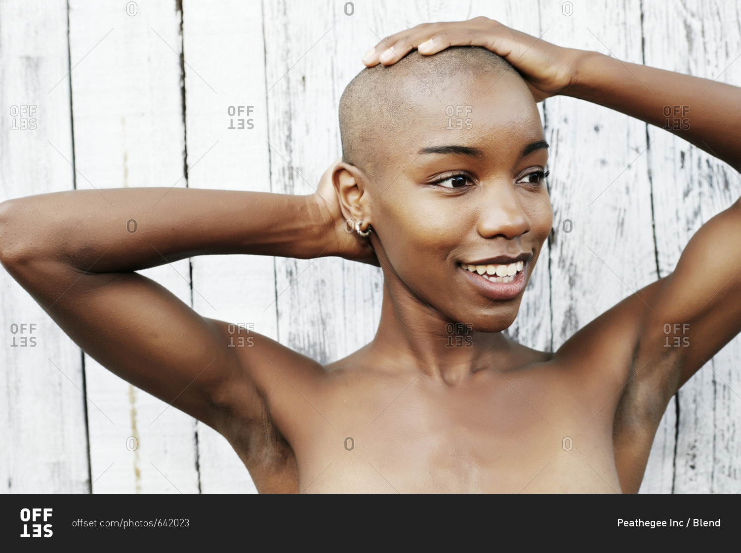 Close up of naked black woman rubbing bald head stock photo - OFFSET