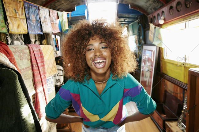 Black woman laughing in retail store on bus