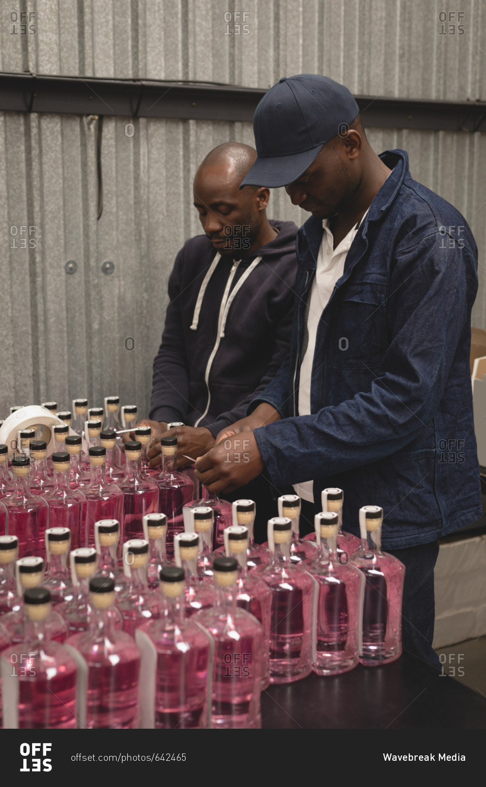 Workers packing gin bottles in the factory