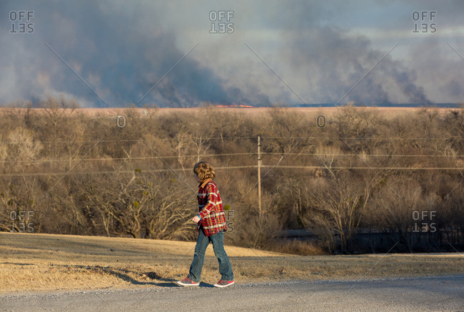 Boy watching wildfire on walk