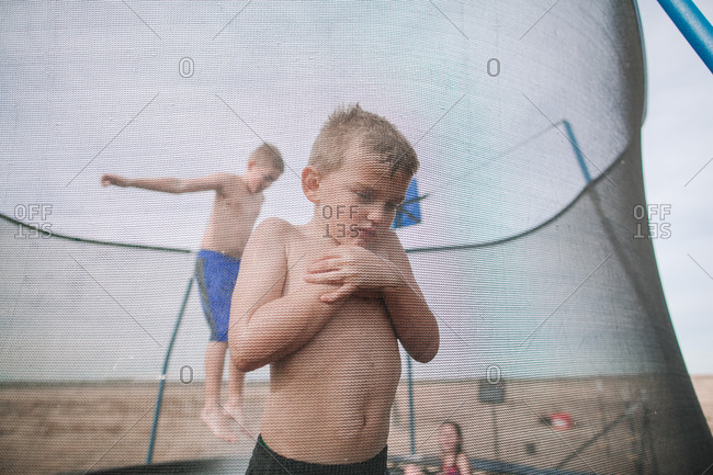 Boy standing on trampoline