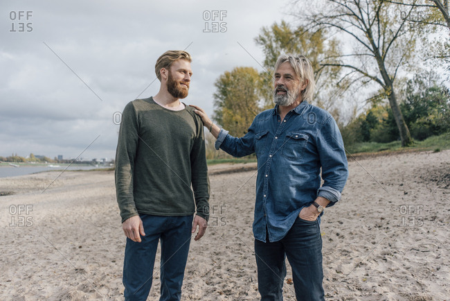 Father and son taking a stroll at Rhine river- meeting to talk