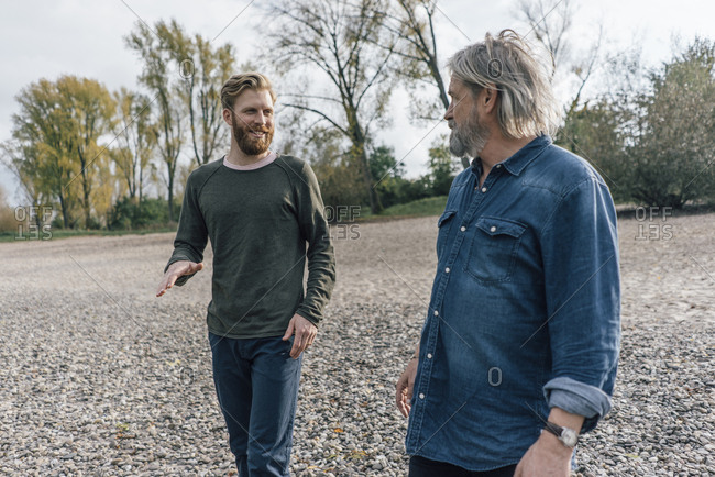 Father and son taking a stroll at Rhine river- meeting to talk