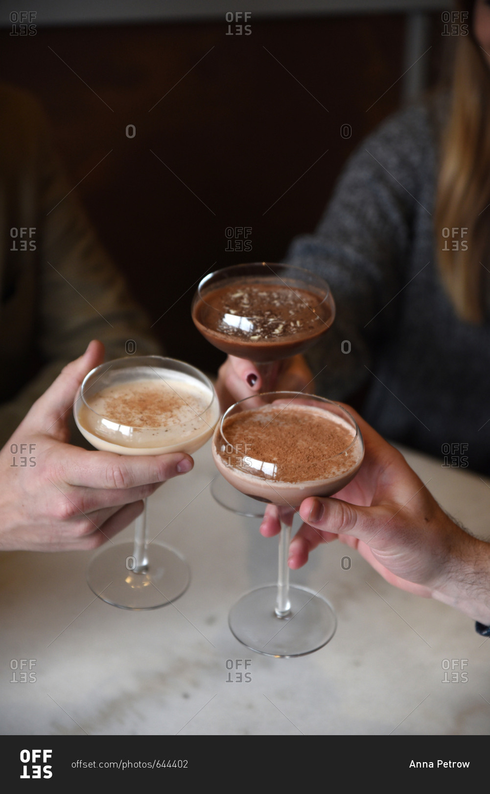 Three people holding dessert drinks