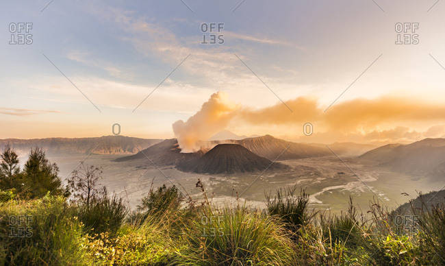 Sunrise, smoking volcano, Gunung Bromo, Mount Batok, Mount Kursi, Mount Semeru, Bromo Tengger Semeru National Park, Java, Indonesia, Asia