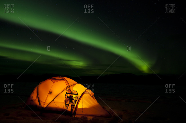 Illuminated expedition tent and traditional wooden snow shoes, Northern Lights, Polar Lights, Aurora Borealis, green, near Whitehorse, Yukon Territory, Canada, North America