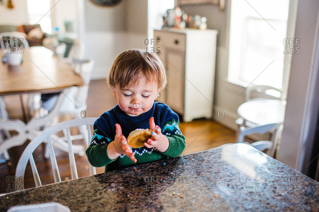 Little boy holding a decorated cookie