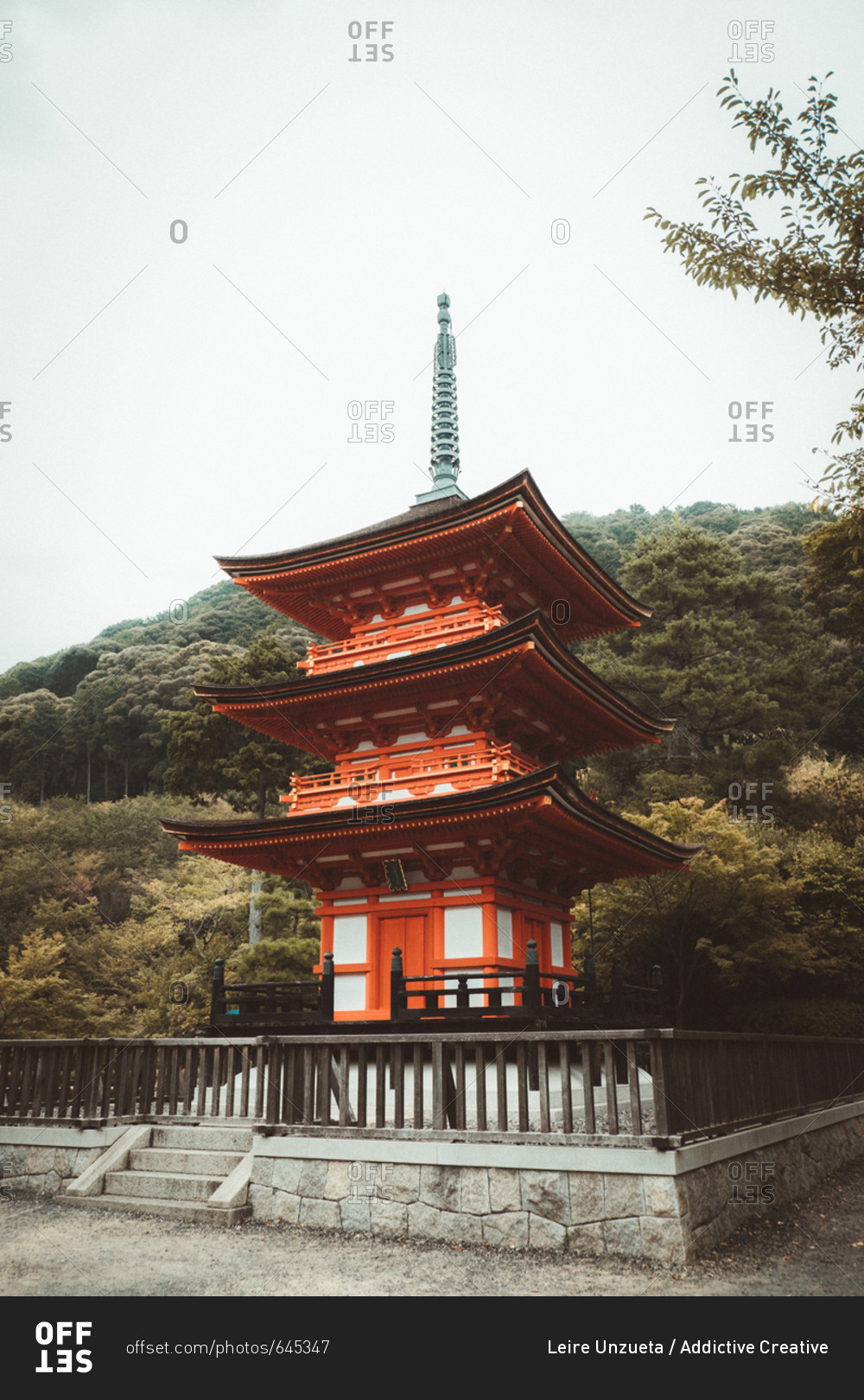 Beautiful Asian shrine standing on background of trees growing on hill