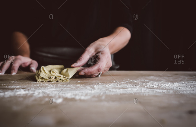 Person making a sheet of homemade pasta dough