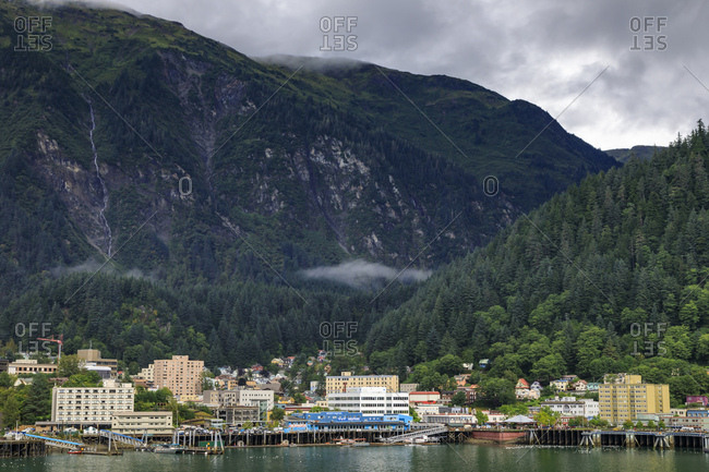 Juneau, Alaska, United States of America, North America - August 30, 2017: Juneau, State Capital, view from the sea, mist clears over downtown buildings, mountains, forest and float planes
