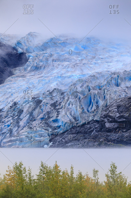 Bright blue ice of Mendenhall Glacier flowing from Juneau Ice Field, mist on Mendenhall Lake, Juneau, Alaska, United States of America, North America