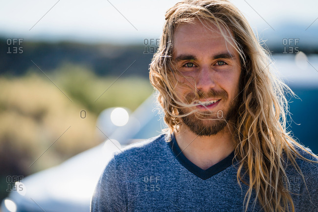 Man With Long Blond Hair Smiling On Sunny Day Stock Photo Offset