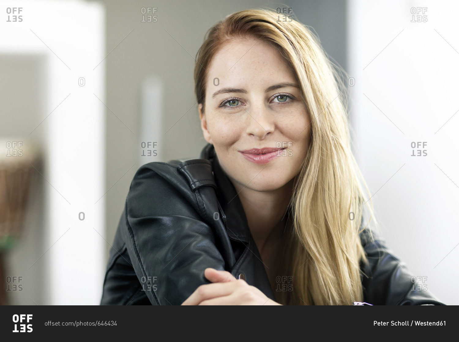 Portrait of smiling young woman wearing leather jacket
