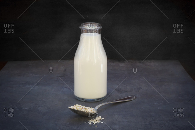 Glass bottle of homemade oat milk with dates