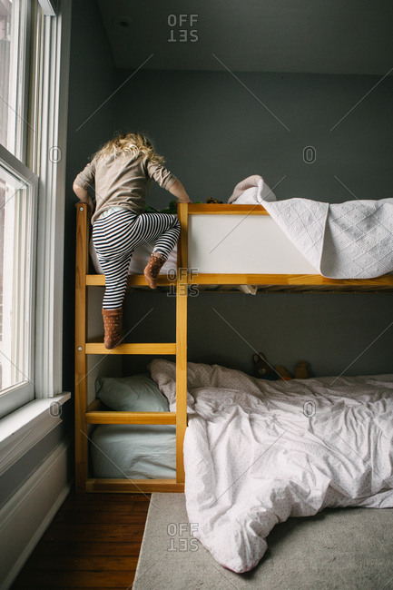 Woman In Ranch Style House Climbing Ladder To Bunk Bed Canvas