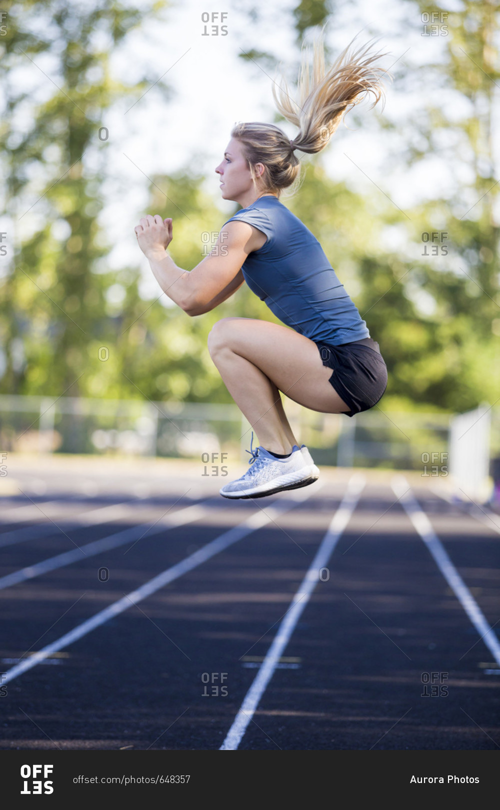 Young woman exercising on track, Eugene, Oregon, USA