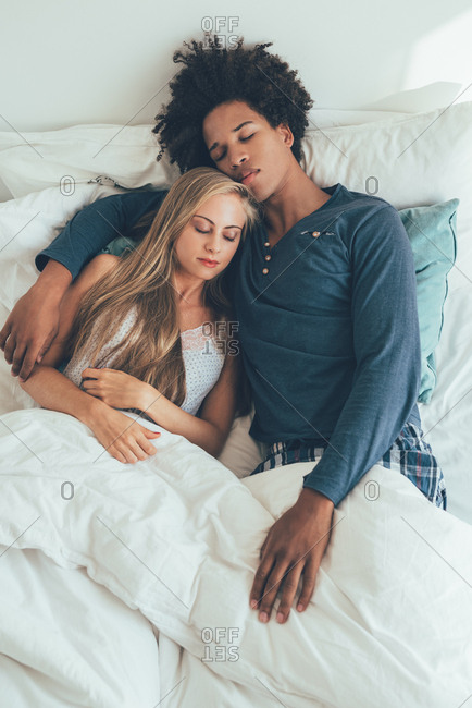 Young Beautiful Interracial Couple In Bed Sleeping Stock