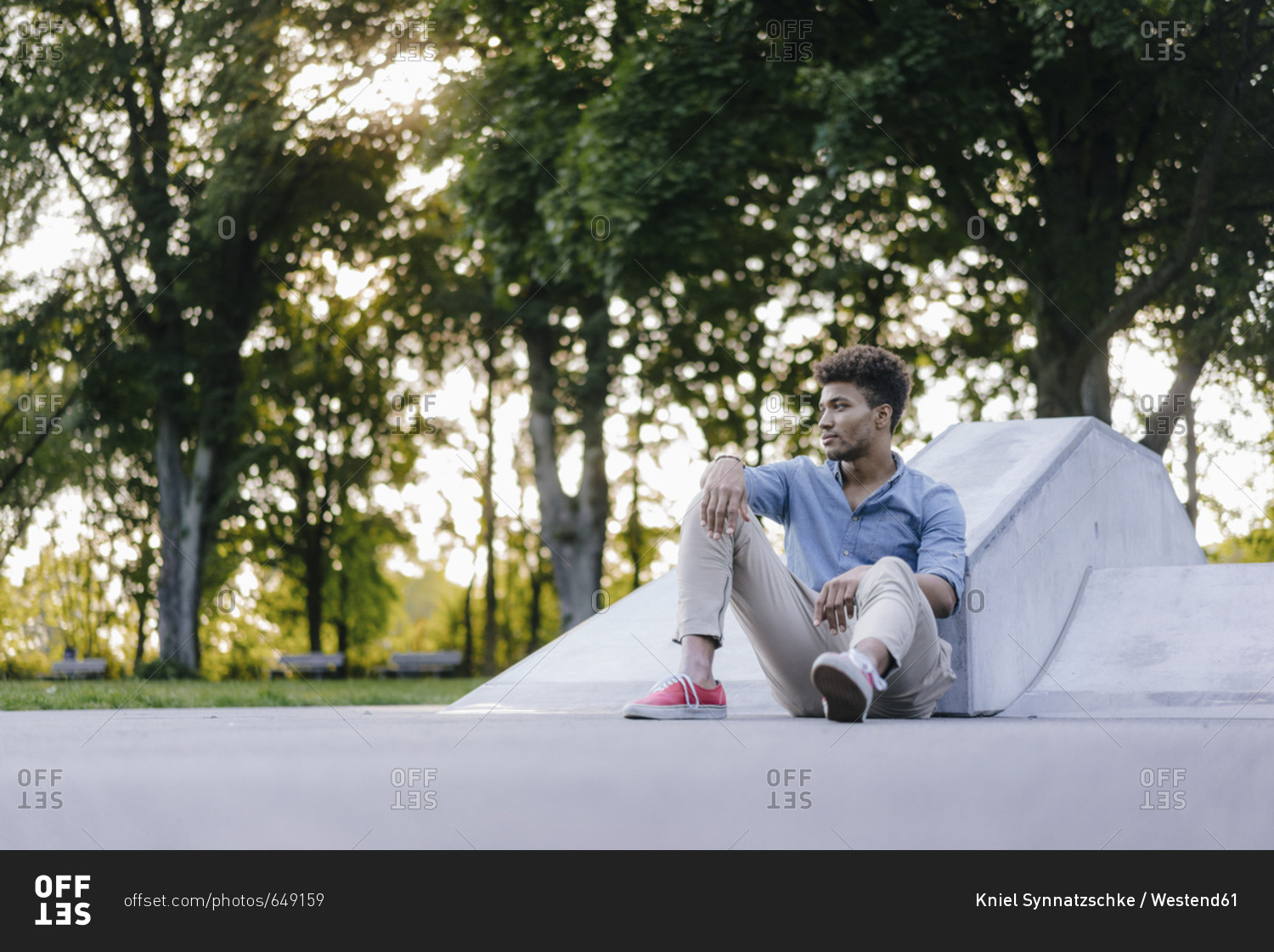 Portrait of relaxed man sitting in skate park