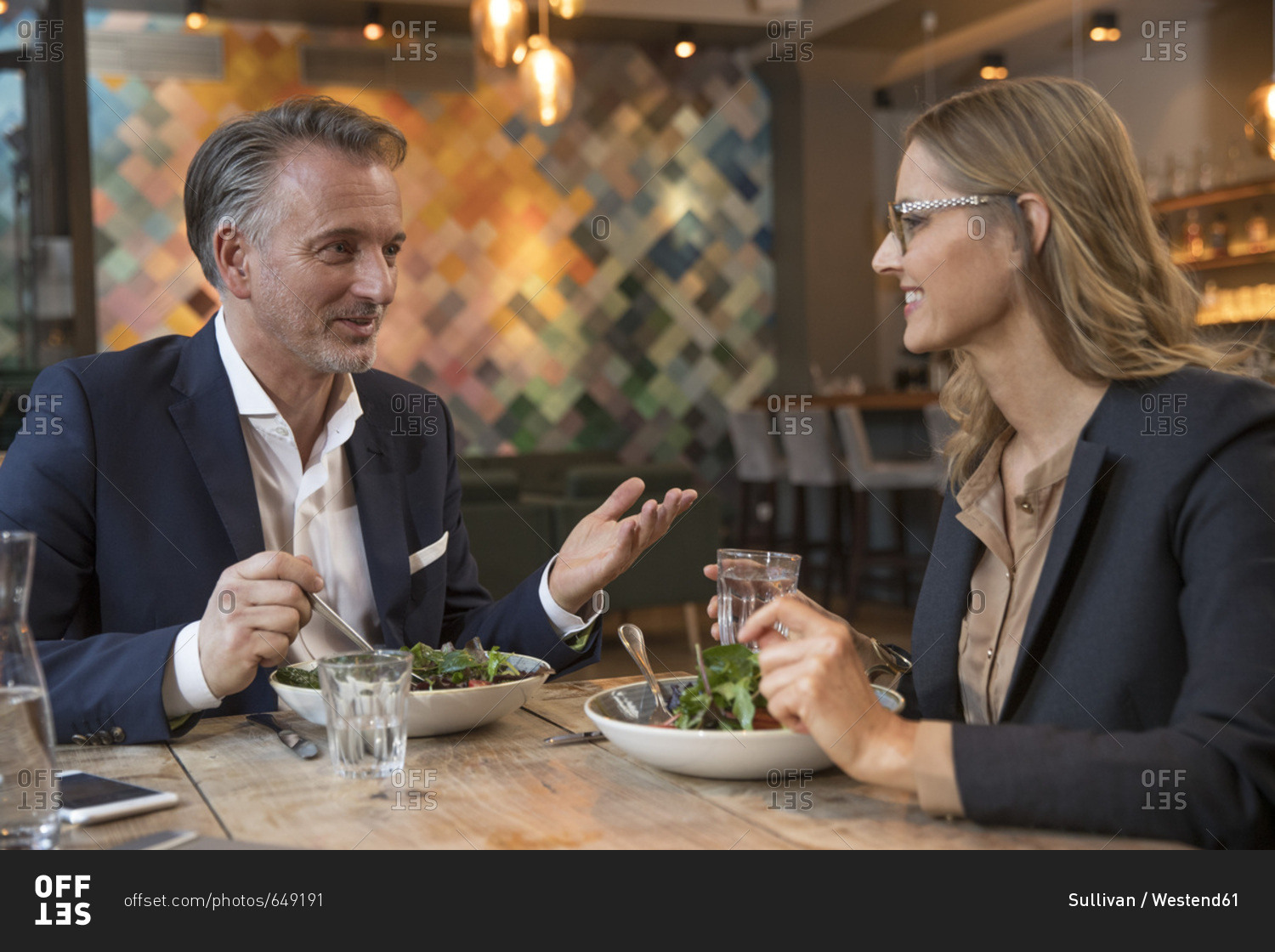 Two business people having lunch in a restaurant