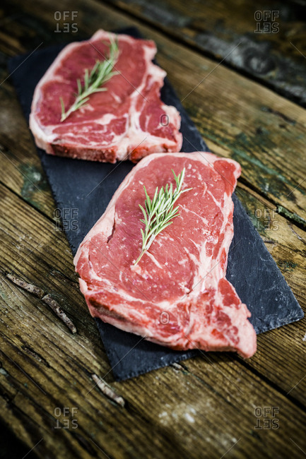 Raw beefsteaks with rosemary - Offset
