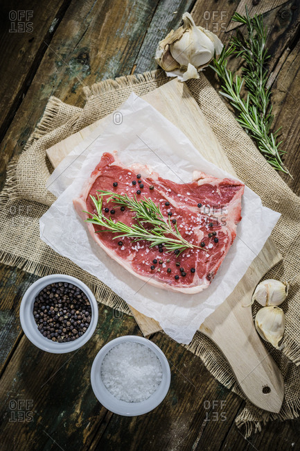 Raw beefsteak with rosemary- salt and pepper