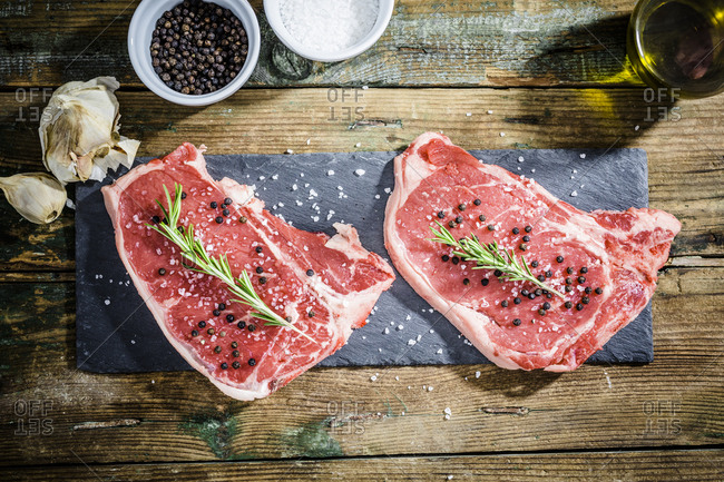 Raw beefsteak with rosemary- salt and pepper