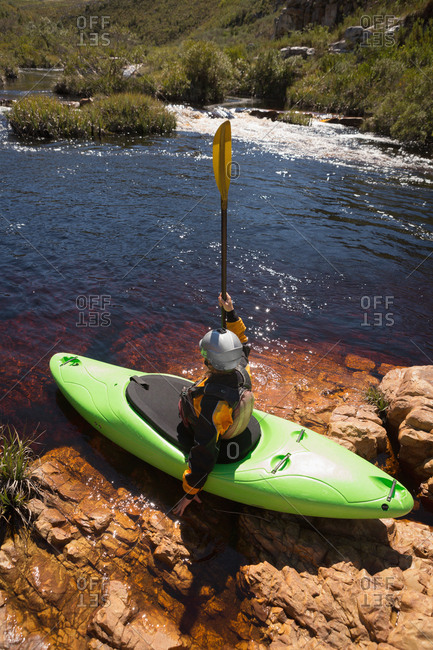 Woman kayaking in river on a sunny day