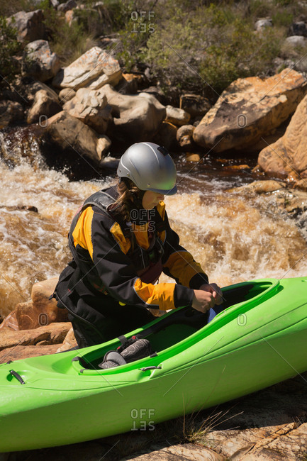 Woman standing with kayak boat on a sunny day