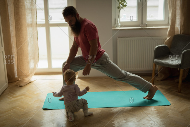 Baby imitating his father while exercising at home